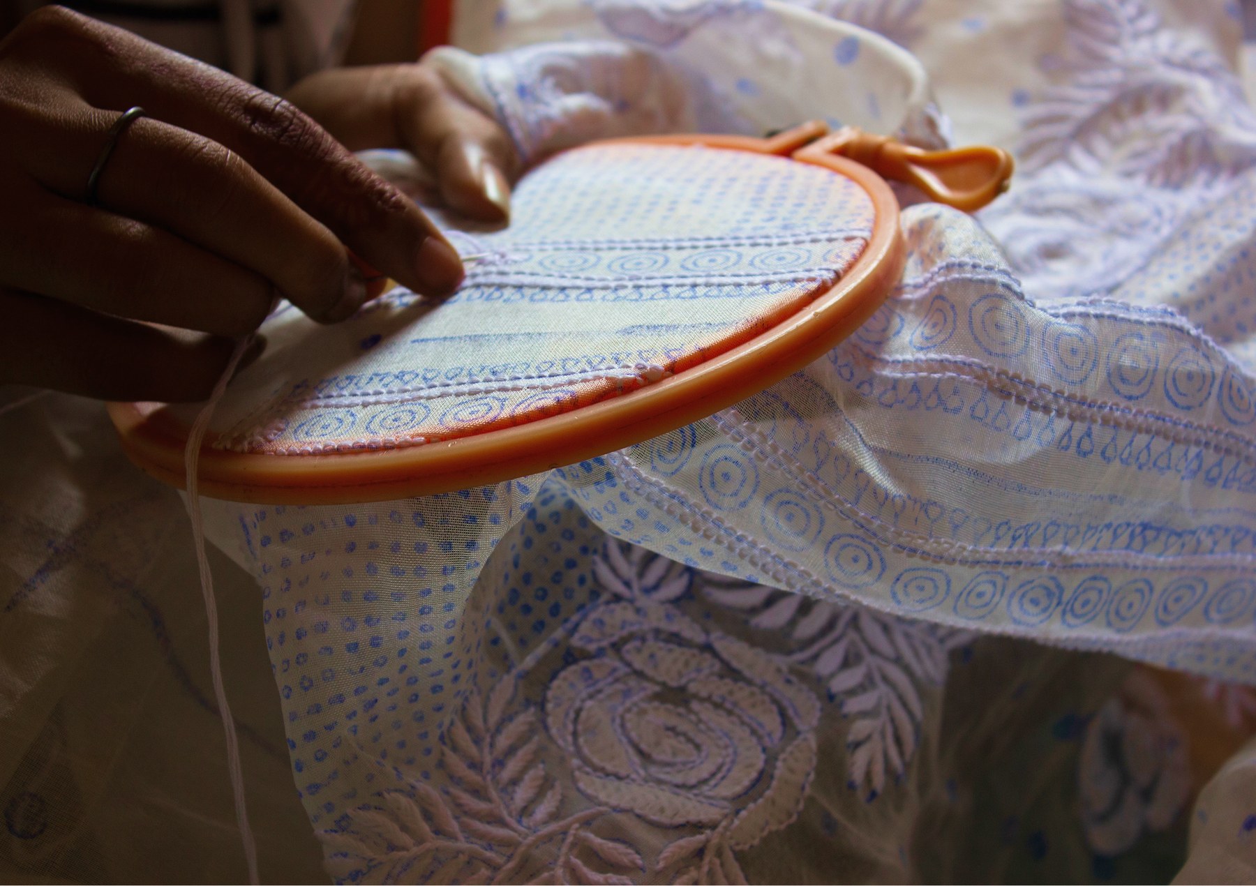 An Ananta garment being embroidered by hand